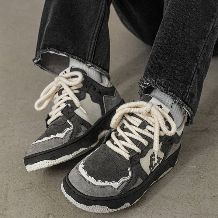 a pair of black and white sneakers with white laces