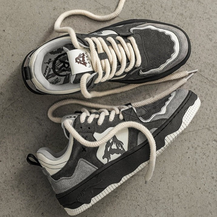 a pair of black and white sneakers with white laces